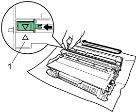 Slide the green tab to clean the corona wire