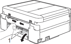 Squeeze both levers, and then open Jam Clear Cover