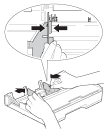 Press and slide the paper guides