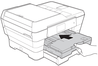 Slowly push the paper tray into the machine