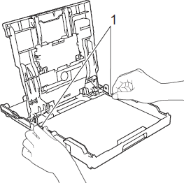 Gently adjust paper guides to fit paper