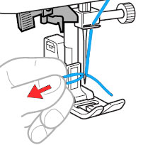 Carefully pull the loop of the thread through the eye of the needle to pull out the end of the thread.