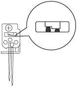 The right needle should be set slightly lower than the left one.